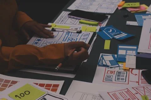 Team of uxui designers pointing at computer screen, discussing new mobile a.. 스톡 사진