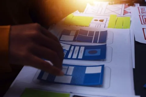 Team of uxui designers pointing at computer screen, discussing new mobile a.. Foto stock