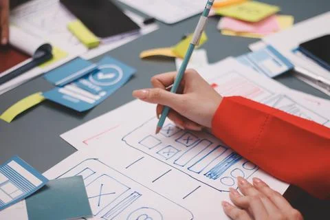 Team of uxui designers pointing at computer screen, discussing new mobile a.. 스톡 사진