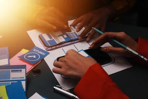 Team of uxui designers pointing at computer screen, discussing new mobile a.. 스톡 사진