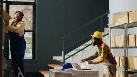 Team of warehouse employees taking boxes from racks Stock Footage 236510990