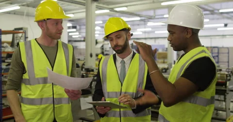 Team of warehouse workers checking inventory on their digital touch screen. Stock Footage 48712385