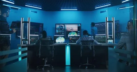 Team watch space rocket launch on big digital screens in mission control center Stock Photos