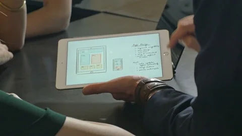 Team of web designers discussing while using digital devices. Stock Footage 80472468