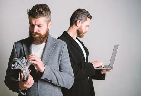 Team of web developer with laptop and sales manager with cash money. Developing Foto stock