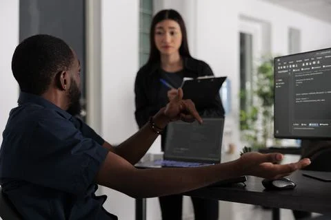 Team of web developers working at coding project compiling algorithm 库存照片