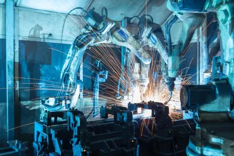 Team welding robots represent the movement. In the automotive parts industry. Stock Photos