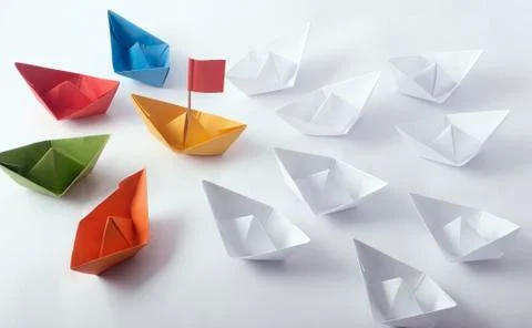 Team Work Concept using  different color Origami Paper Boats Stock Photos