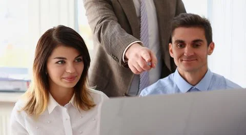 Team work on desktop computer, boss point on screen, this one, perfect choice Stock Photos