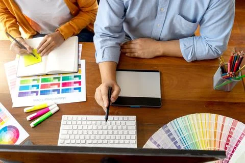 Team work for graphic design working on wood table Stock Photos