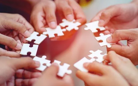Team work, hands and jig Saw Unite with power Is a good team of successful .. Stock Photos