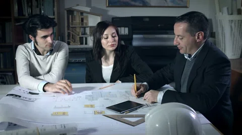 Team work: project team at work on blueprints: architect studio Stock-Footage 49773794