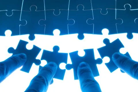 Team work on solving puzzle problem Fotos Stock