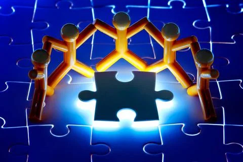 Team work on solving puzzle problem Team work on solving puzzle problem. T... Stock Photos