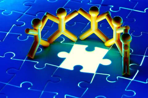 Team work on solving puzzle problem Team work on solving puzzle problem. T... Stock Photos