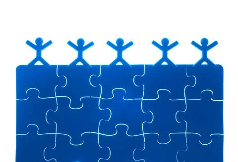 Team work on solving puzzle problem Team work on solving puzzle problem. T... Stock Photos