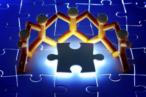 Team work on solving puzzle problem. Team work concept. Stock Photos