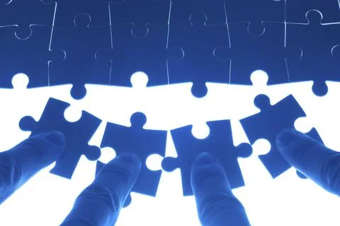 Team work on solving puzzle problem. Team work concept. Stock Photos