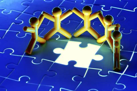 Team work on solving puzzle problem. Team work concept. Stock Photos