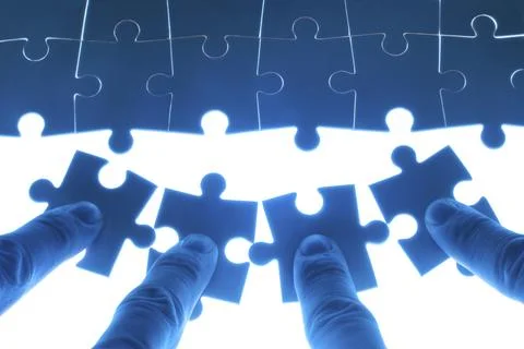 Team work on solving puzzle problem. Team work concept. Stock Photos