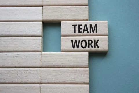 TEAM WORK symbol. Concept word TEAM WORK on wooden blocks. Beautiful grey g.. Stock Photos
