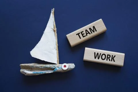 TEAM WORK symbol. Concept word TEAM WORK on wooden blocks. Beautiful deep b.. Stock Photos