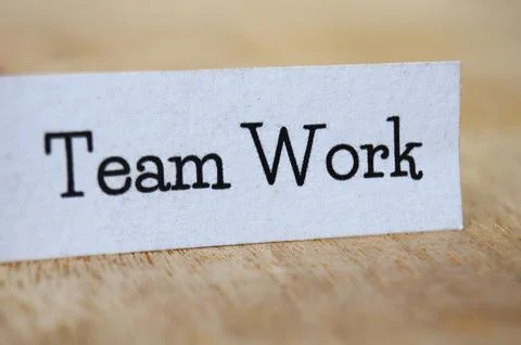 Team work text on white paper on wooden table Stock Photos