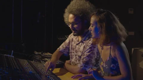 Team work. Working process. Hispanic man and woman working in the music studio Stock Footage 139143665