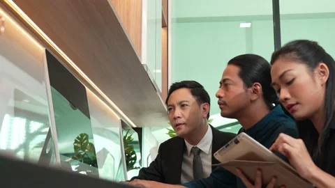 Team worker considering company statistics in laptop at office desk Stock Footage 171967138