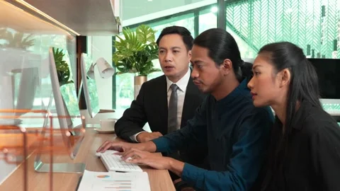 Team worker considering company statistics in laptop at office desk Stock Footage 171967139