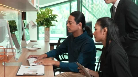 Team worker considering company statistics in laptop at office desk Stock Footage 171967151