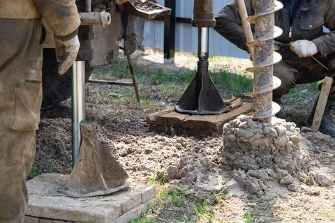 Team of workers with drilling rig on car are drilling artesian well for wat.. Stock Photos
