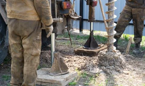 Team of workers with drilling rig on car are drilling artesian well for wat.. Stock Photos