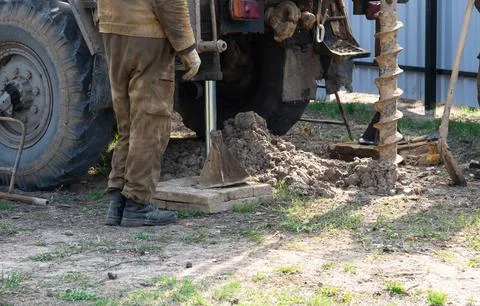 Team of workers with drilling rig on car are drilling artesian well for wat.. Stock Photos