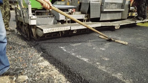 A team of workers makes road surface repair, reconstruction. Stock Footage 137868323