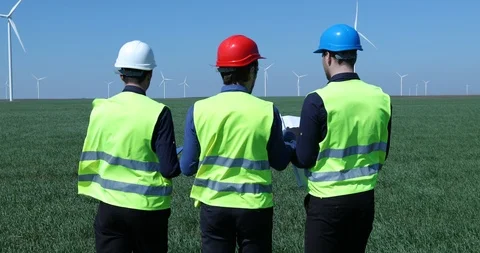 Team of Workers Men Walking on Wind Turbine Field Talking Planning Work Activity Stock Footage 87979400