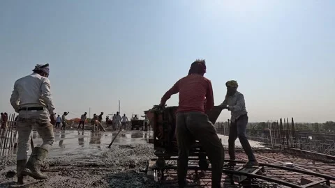 Team of workers operating a concrete hopper cart on a construction site Stock Footage 343910640