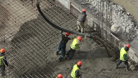 Team of workers pouring concrete Stock Footage 105463309