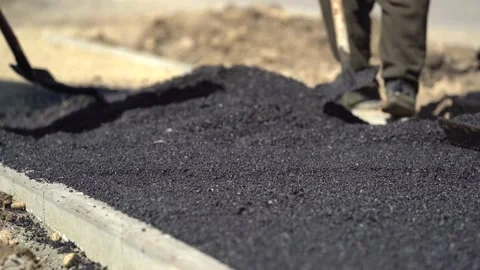 Team of workers put the hot asphalt on a street along tram car's railroad lines Stock-Footage 172397601