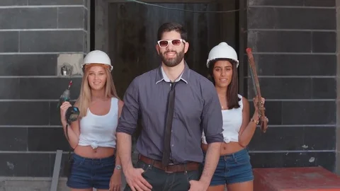 Team working and smiling at the construction site wearing helmet Stock Footage 81731009