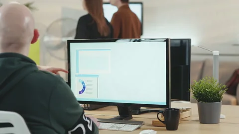 Team working in start-up office at computer workstation Stock Footage 149242734