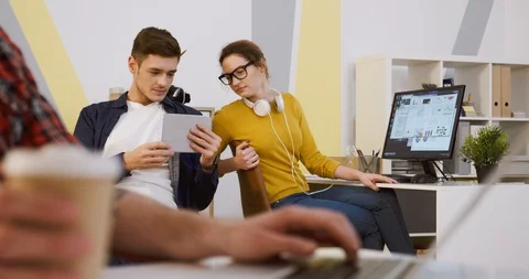 Team working of young start-uppers. Man and woman in casual style talking and Stock Footage 88461870