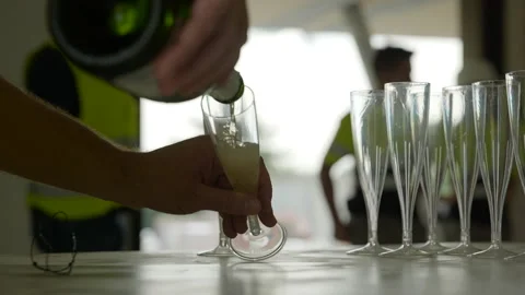 Team in yellow high visibility vests celebrating business deal pouring Stock Footage 224482002