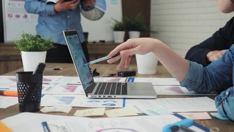 Team of young business managers analyzing data using computer in the office Stock Footage 95568007
