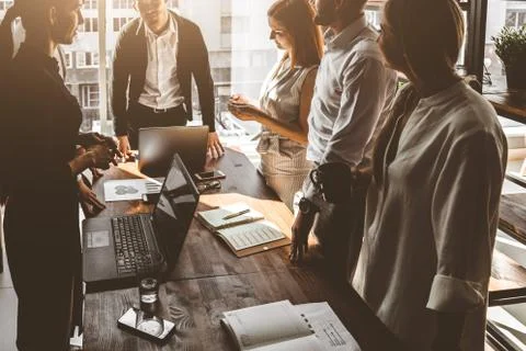 A team of young businessmen working and communicating together in an office Stock Photos