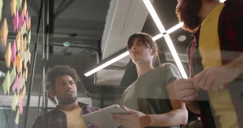 Team of young developers brainstorming, looking for creative ideas and writing Stock Footage 156339113