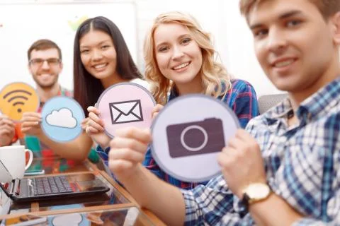 Team of young developers sitting at the table Stock Photos