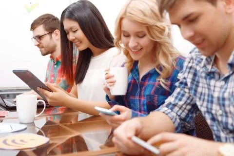 Team of young developers sitting at the table Stock Photos