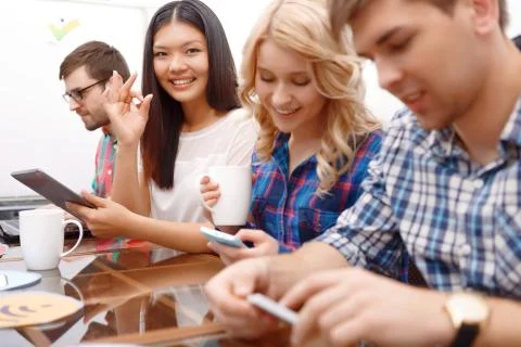 Team of young developers sitting at the table Stock Photos