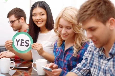 Team of young developers sitting at the table Stock Photos